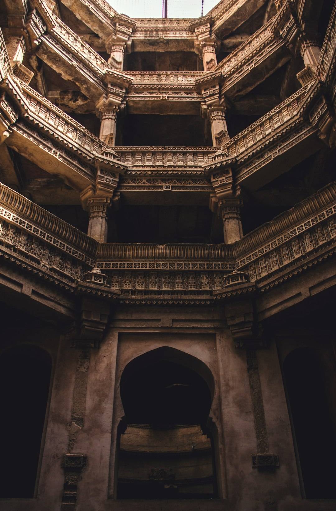Carved sandstone steps and pillars descending into the Adalaj stepwell near Ahmedabad