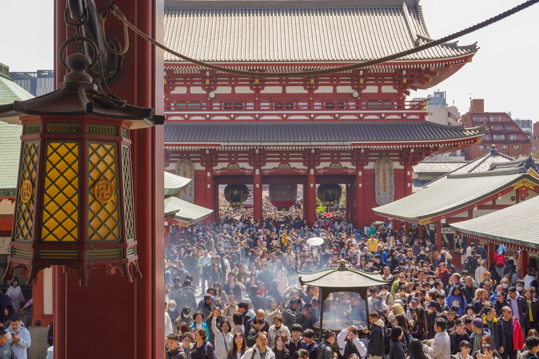 A crowd of visitors at a traditional Japanese shrine, similar to the millions who make Hatsumode visits to Meiji Jingu in early January