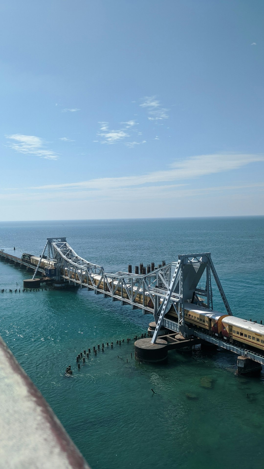 A train crossing a sea bridge in Tamil Nadu, like the Pamban bridge between Mandapam and Rameswaram