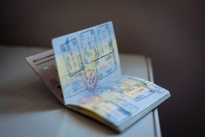 An open passport with numerous colorful visa and entry stamps covering its pages
