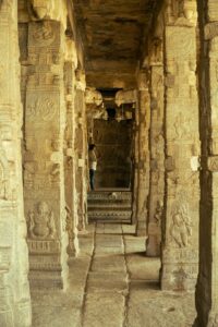Carved stone pillars lining a long South Indian temple corridor, like Ramanathaswamy's third corridor