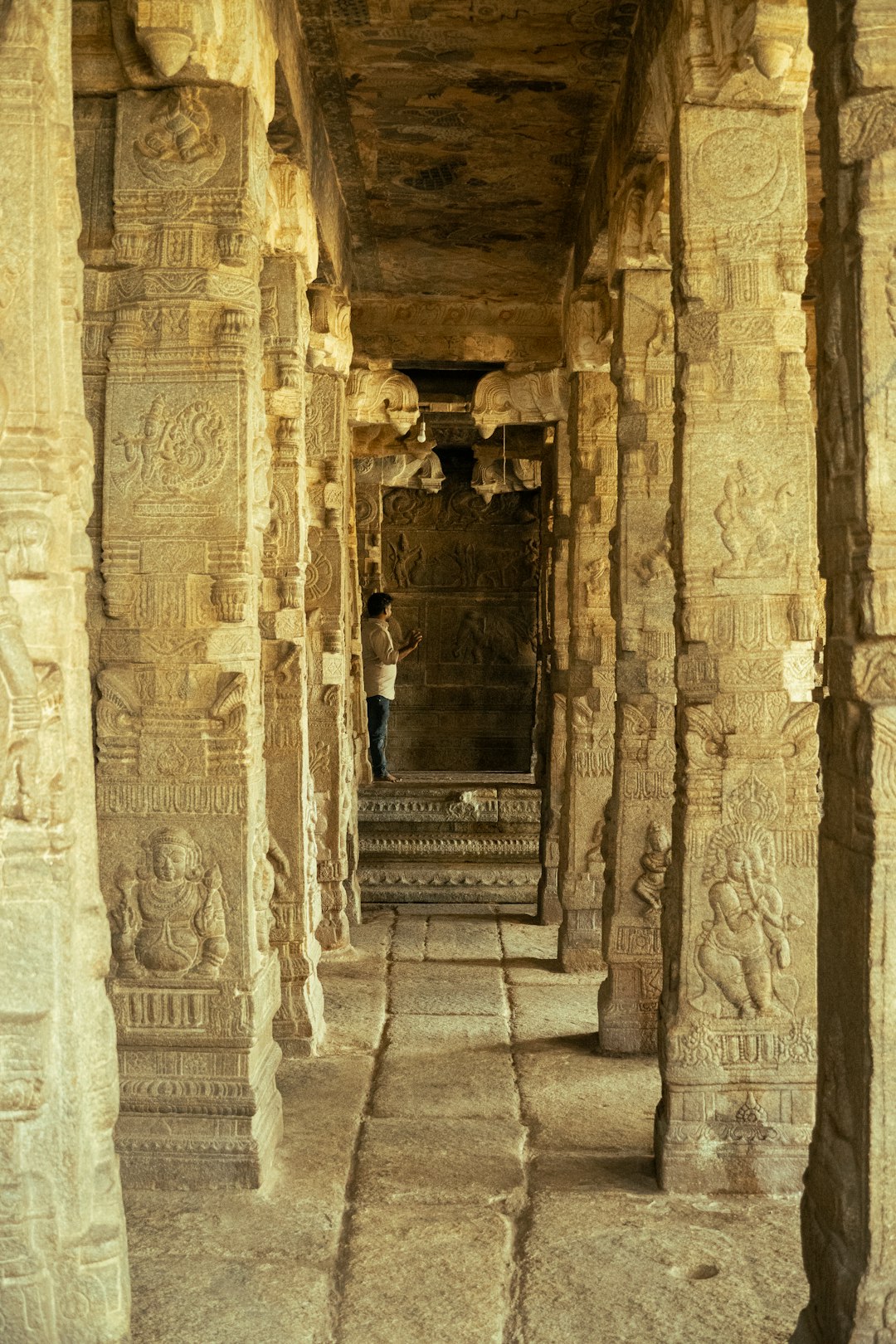 Carved stone pillars lining a long South Indian temple corridor, like Ramanathaswamy's third corridor