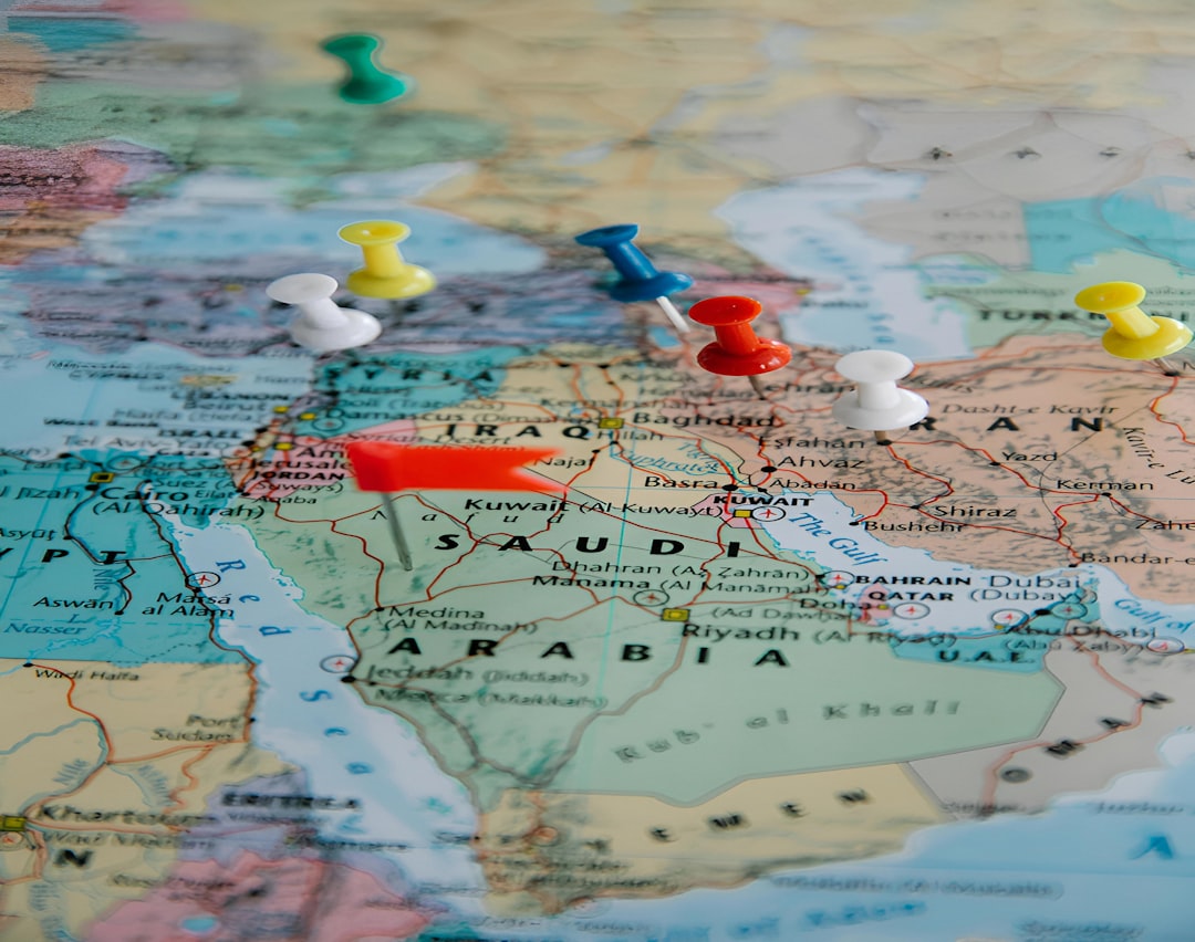 Colorful pushpins marking visited locations across a paper world map