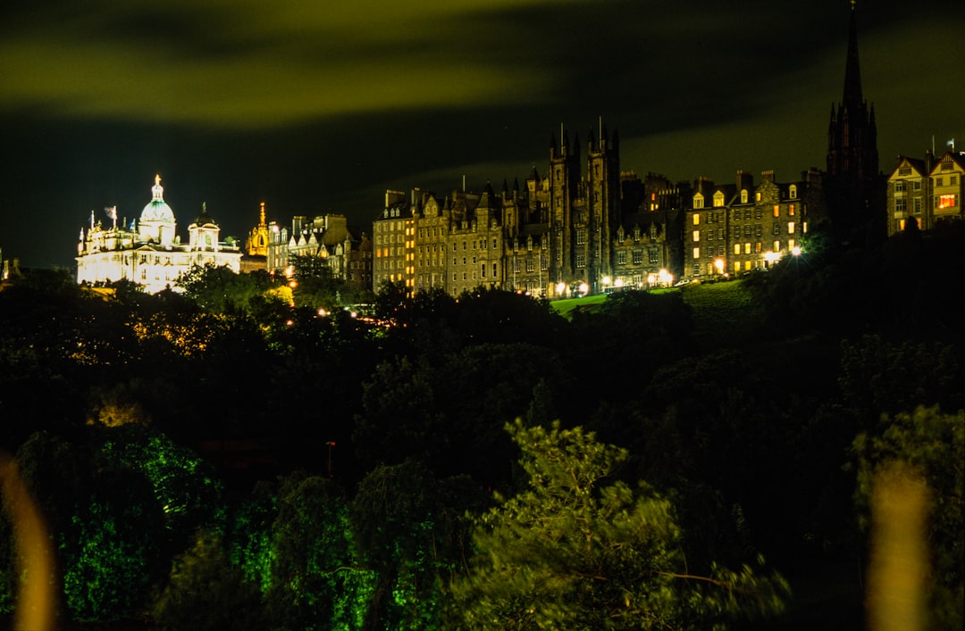 Edinburgh at night with the castle floodlit above the city skyline during Hogmanay
