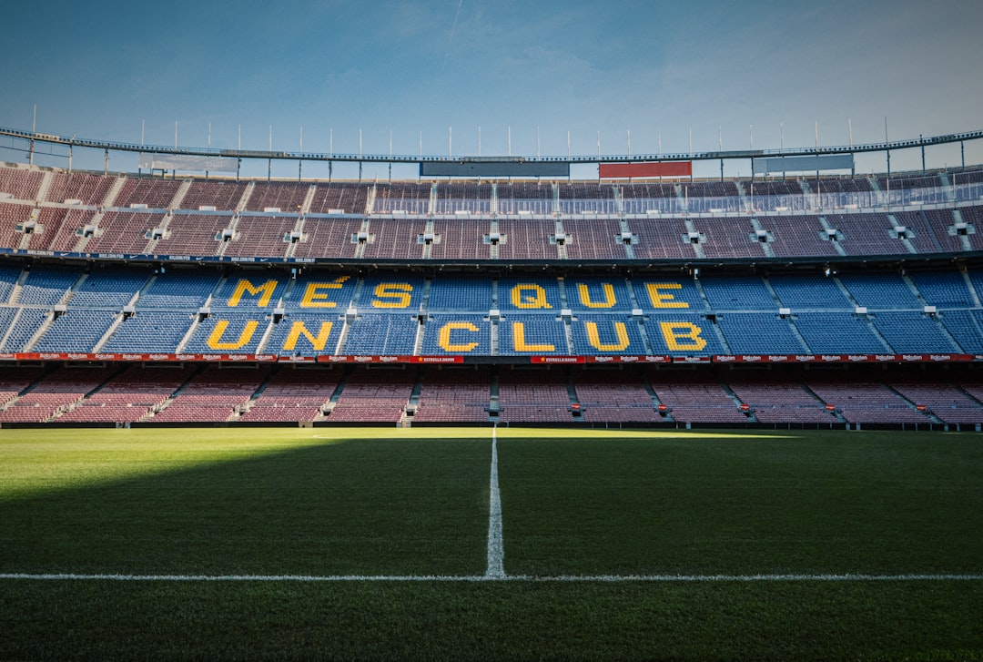 Empty stadium seating reading 'Més que un club' at Camp Nou, Barcelona, mid-reconstruction