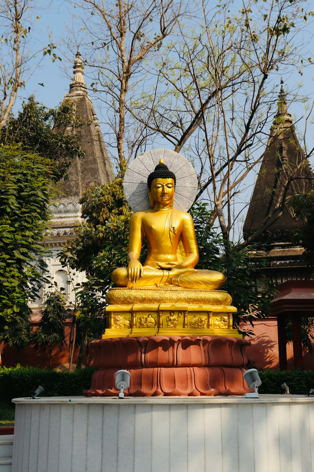 Golden Buddha statue in front of the Mahabodhi Temple complex at Bodh Gaya
