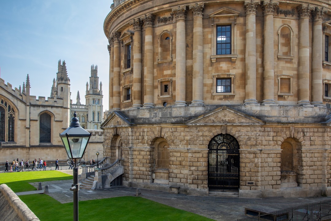 Historic Oxford college stone building with arched windows and towers, the kind of setting summer-school brochures photograph
