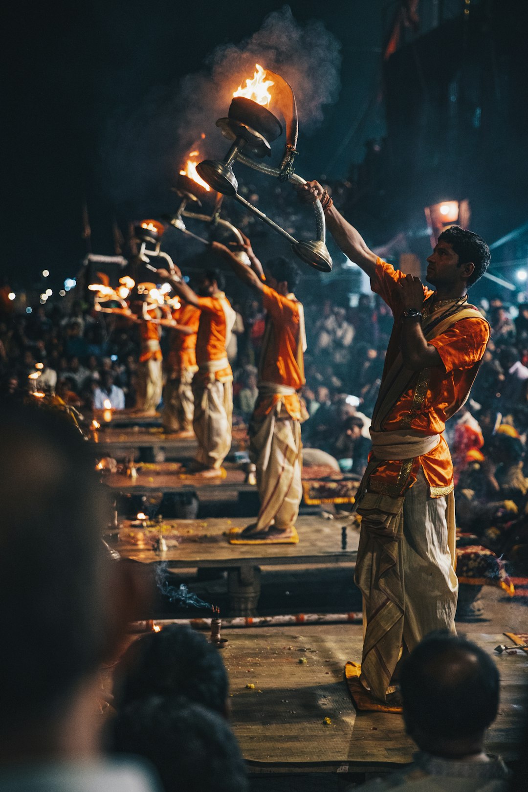 Priests performing the Ganga aarti fire ritual with lamps on the ghats of Varanasi