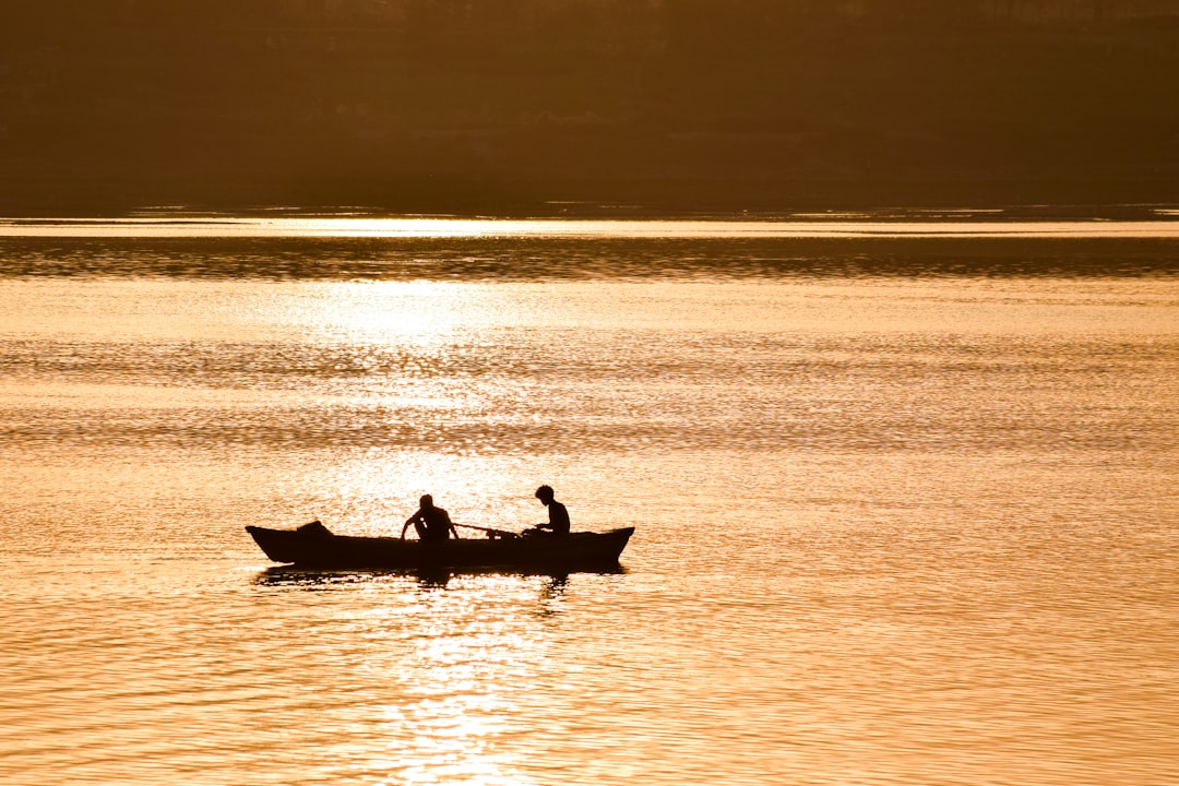 Silhouette of a boat on the Ganges at sunrise in Varanasi