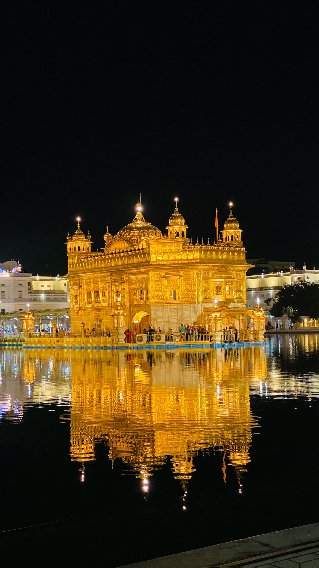 The Golden Temple in Amritsar illuminated at night, reflecting in the surrounding pool during Bandi Chhor Divas