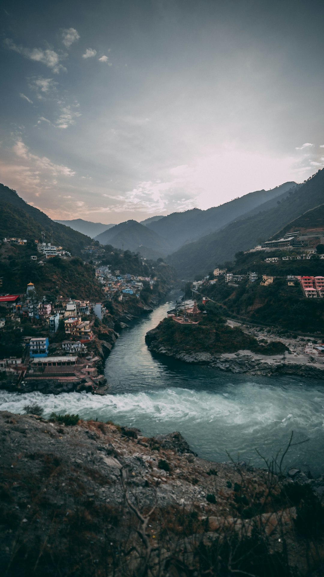 Two Himalayan rivers meeting in a mountain valley, like the Panch Prayag confluences on the Alaknanda